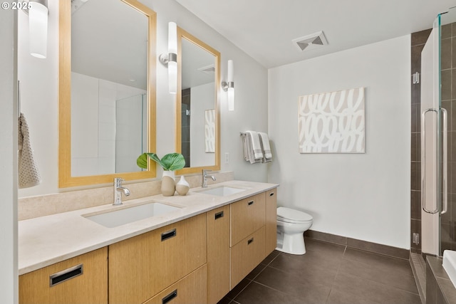full bath with a sink, a shower stall, toilet, and visible vents