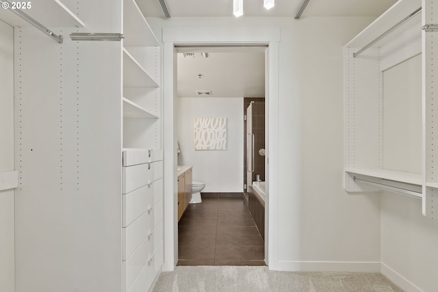 walk in closet with tile patterned floors