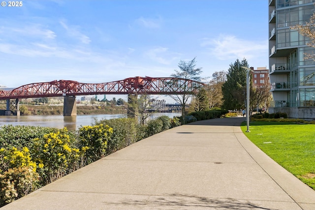 surrounding community featuring a yard and a water view