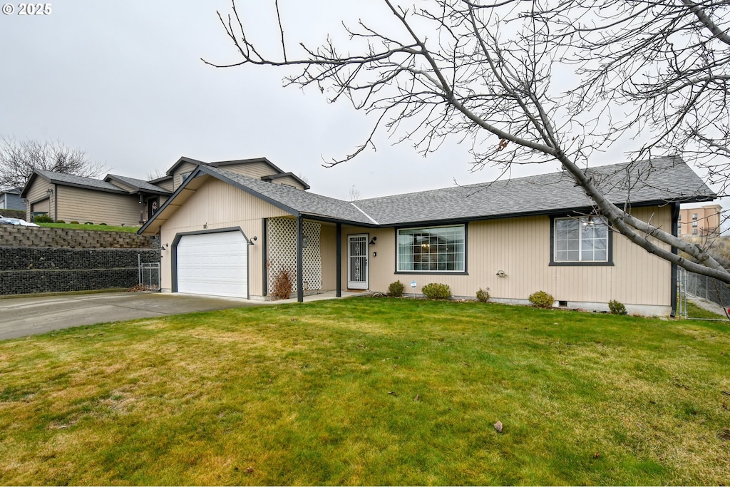 view of front of property with a garage and a front lawn