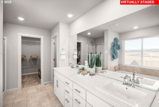 31766 NW Turel Dr, North Plains, OR 97133 - bathroom featuring a stall shower, double vanity, a spacious closet, tile patterned flooring, and recessed lighting
