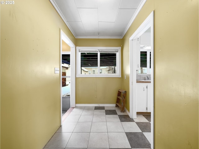 entryway featuring light tile patterned floors and crown molding