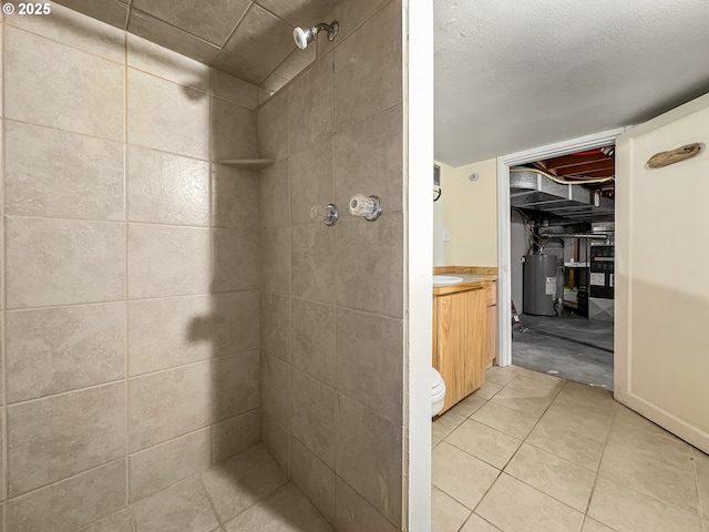 full bath with water heater, a tile shower, and vanity