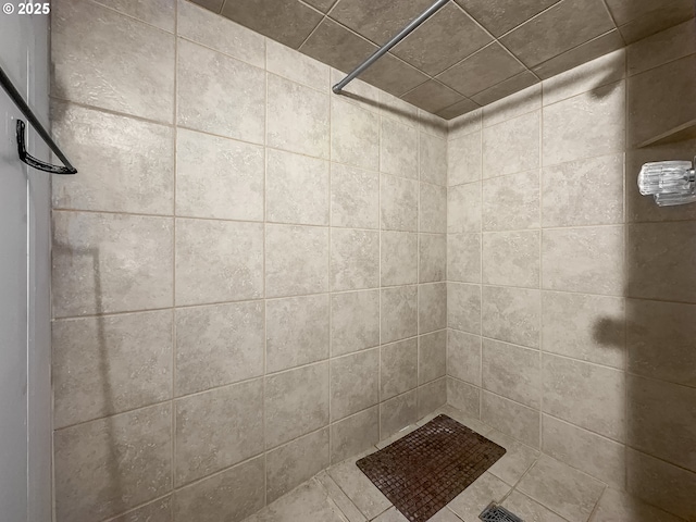 bathroom with tiled shower