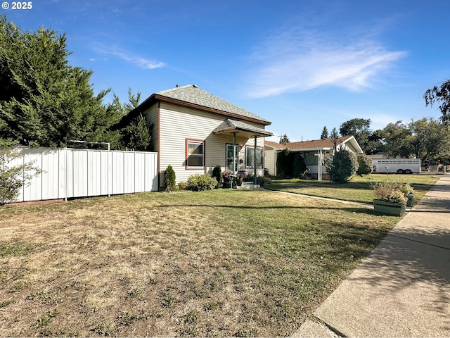 view of property exterior featuring a yard and fence