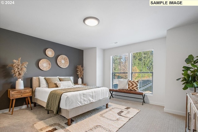 bedroom featuring light carpet