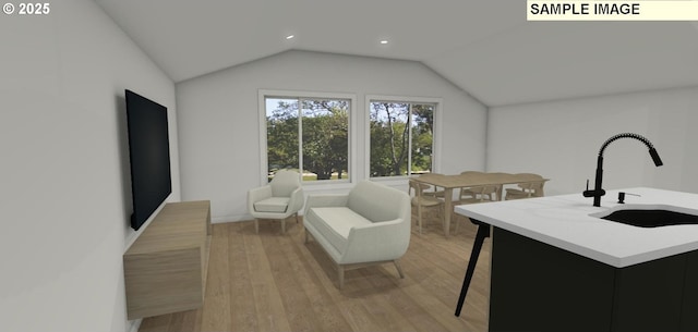 living room with lofted ceiling, sink, and light hardwood / wood-style flooring