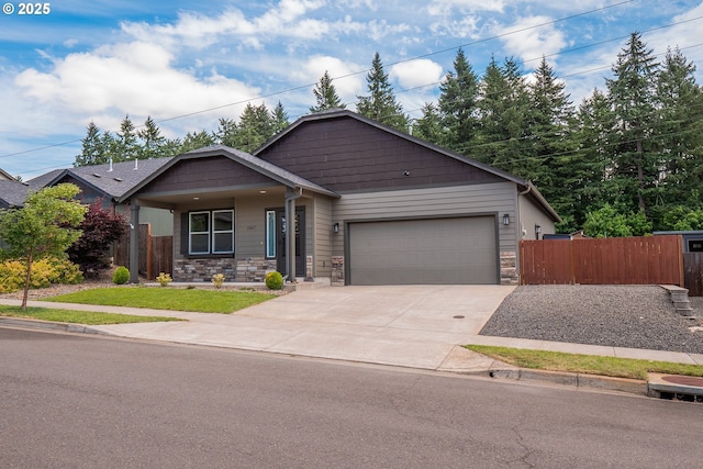 1067 S 55th St, Springfield, OR 97478 - single story home featuring concrete driveway, stone siding, and a garage