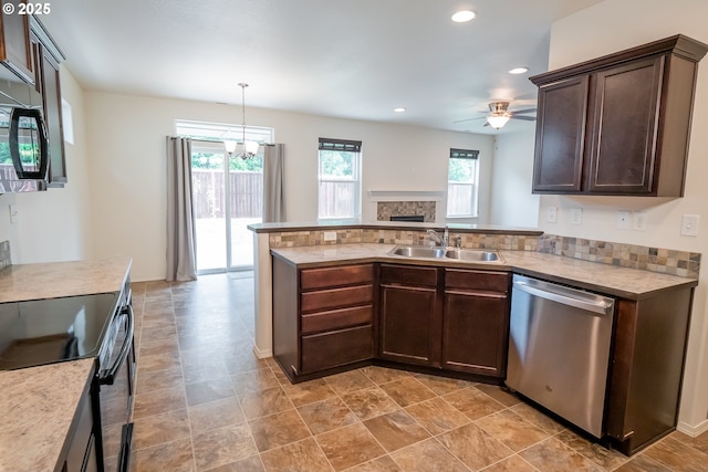 1067 S 55th St, Springfield, OR 97478 - kitchen featuring stainless steel appliances, dark brown cabinetry, a fireplace, a peninsula, and light countertops