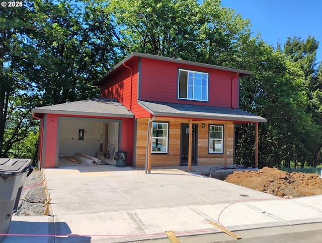 1027 Highlands Loop, Willamina, OR 97396 - view of front facade featuring a garage, covered porch, and concrete driveway