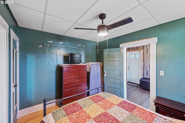 380 3rd Ave, Powers, OR 97466 - bedroom with wood finished floors, a paneled ceiling, baseboards, and ceiling fan