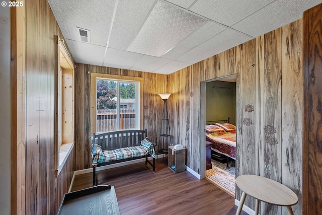 380 3rd Ave, Powers, OR 97466 - living area with wood walls, wood finished floors, a paneled ceiling, and baseboards