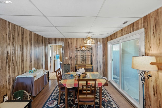 380 3rd Ave, Powers, OR 97466 - dining space with a paneled ceiling, wood walls, and wood finished floors