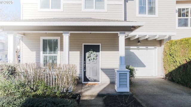 doorway to property featuring a garage and covered porch