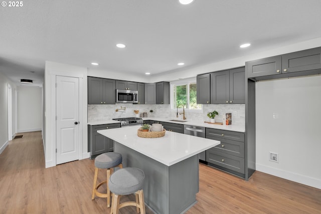 37465 Dubarko Rd, Sandy, OR 97055 - kitchen featuring light wood-type flooring, backsplash, light countertops, and recessed lighting