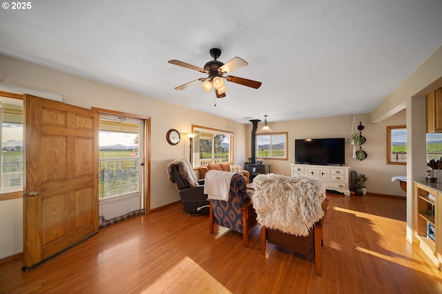 4664 N Mckay Rd, Prineville, OR 97754 - living room with wood finished floors, a ceiling fan, and baseboards