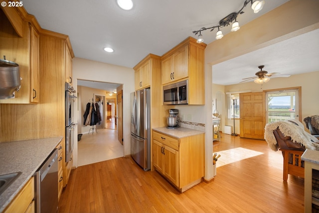 4664 N Mckay Rd, Prineville, OR 97754 - kitchen with stainless steel appliances, light wood finished floors, a ceiling fan, open floor plan, and a sink