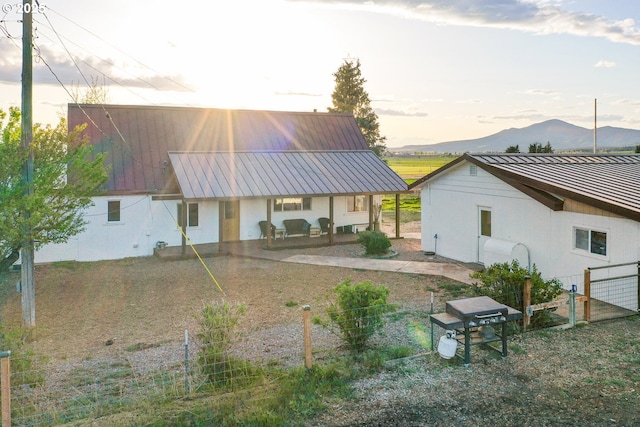 4664 N Mckay Rd, Prineville, OR 97754 - back of house featuring fence, a mountain view, and metal roof