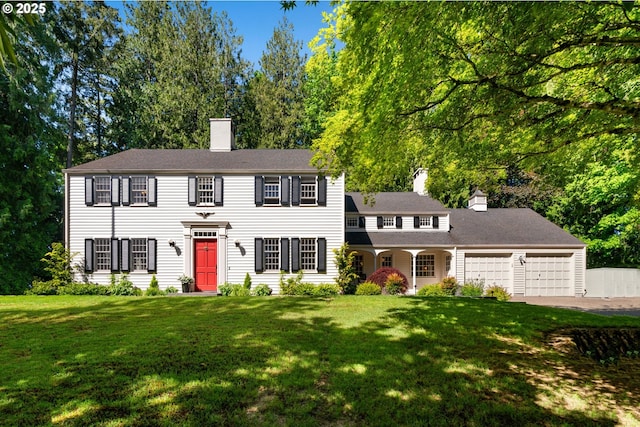 7330 SW Dogwood Pl, Portland, OR 97225 - colonial house with a chimney, a garage, a front lawn, and driveway
