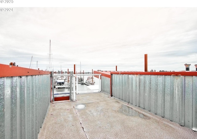 view of patio featuring a boat dock and a water view