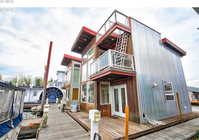 back of property with french doors and a balcony