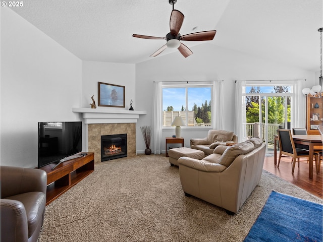 37149 Emerald Cascade, Sandy, OR 97055 - living area with lofted ceiling, plenty of natural light, a ceiling fan, a tile fireplace, and a chandelier