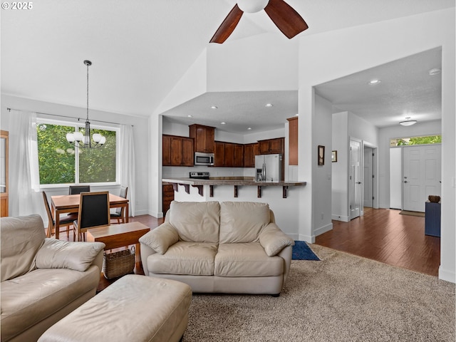 37149 Emerald Cascade, Sandy, OR 97055 - living area with plenty of natural light, a chandelier, a ceiling fan, lofted ceiling, and wood finished floors