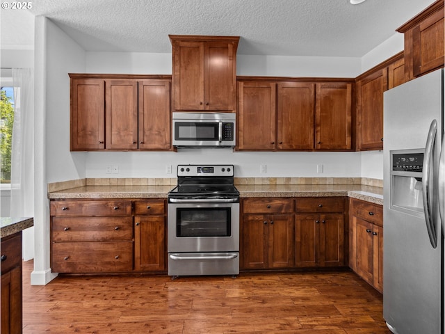 37149 Emerald Cascade, Sandy, OR 97055 - kitchen featuring stainless steel appliances, dark wood finished floors, a textured ceiling, and tile countertops