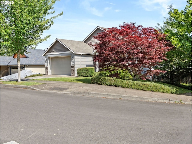 37149 Emerald Cascade, Sandy, OR 97055 - view of property hidden behind natural elements featuring stone siding, an attached garage, and concrete driveway
