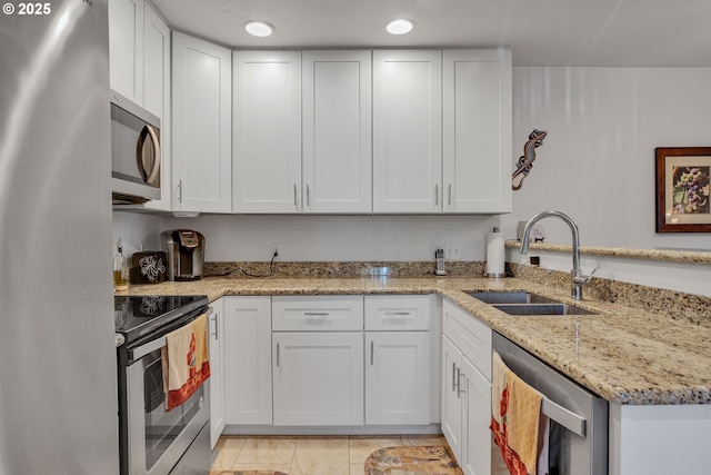 kitchen featuring a sink, stainless steel appliances, and white cabinetry