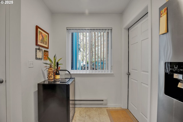 doorway to outside featuring a baseboard heating unit and baseboards