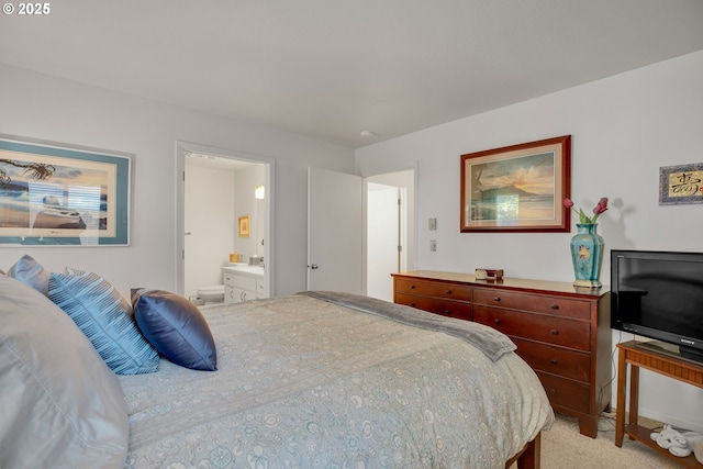 bedroom featuring ensuite bath and light colored carpet