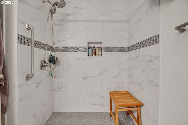 full bath with a tile shower