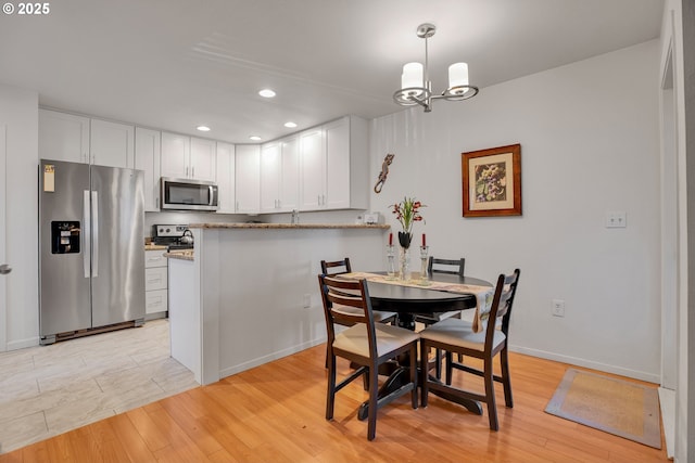 dining area featuring recessed lighting, light wood-style floors, a chandelier, and baseboards