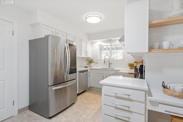 13440 SW Greenleaf Pl, Beaverton, OR 97005 - kitchen featuring appliances with stainless steel finishes, a sink, light countertops, and white cabinetry