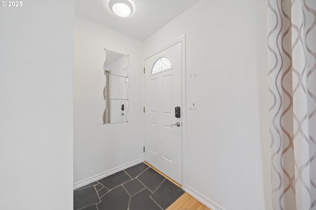 13440 SW Greenleaf Pl, Beaverton, OR 97005 - foyer entrance with baseboards, a textured ceiling, and dark tile patterned flooring