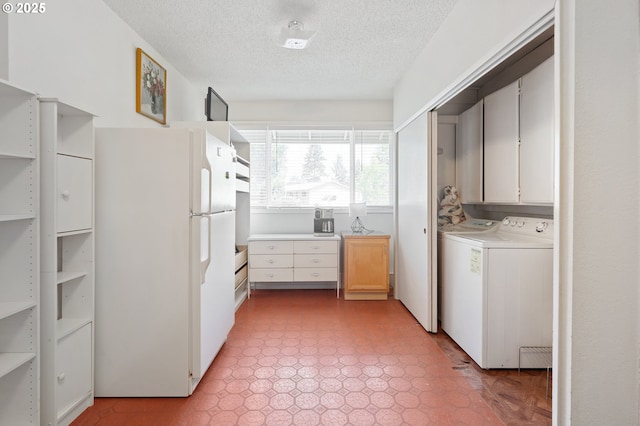 13440 SW Greenleaf Pl, Beaverton, OR 97005 - kitchen with freestanding refrigerator, washer / clothes dryer, a textured ceiling, light countertops, and white cabinets