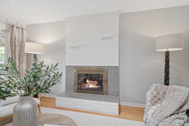 13440 SW Greenleaf Pl, Beaverton, OR 97005 - living room featuring a glass covered fireplace, wood finished floors, and baseboards