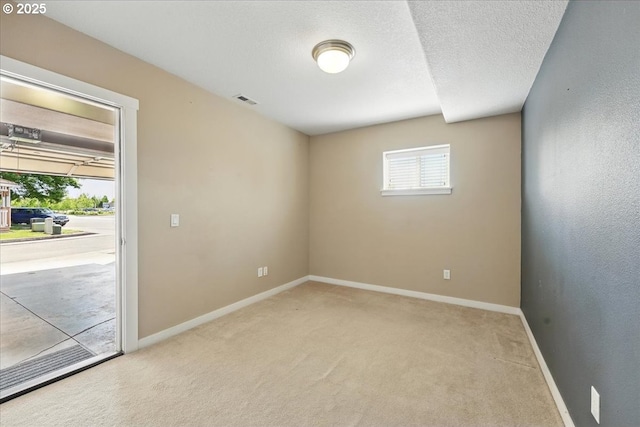 unfurnished room featuring carpet flooring and baseboards