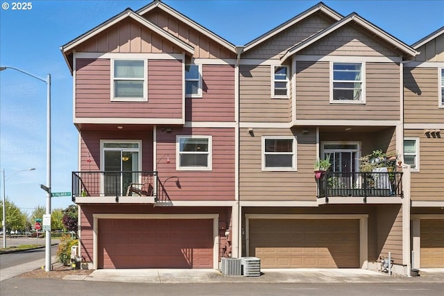 townhome / multi-family property with board and batten siding and an attached garage