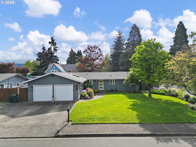 ranch-style home featuring a garage, fence, concrete driveway, and a front lawn