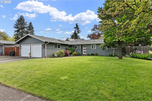 single story home featuring fence, a front yard, driveway, and a garage