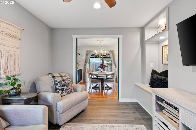 sitting room with recessed lighting, baseboards, ceiling fan with notable chandelier, and wood finished floors