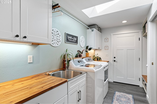 laundry room with washer and dryer, dark wood-style flooring, cabinet space, recessed lighting, and a skylight