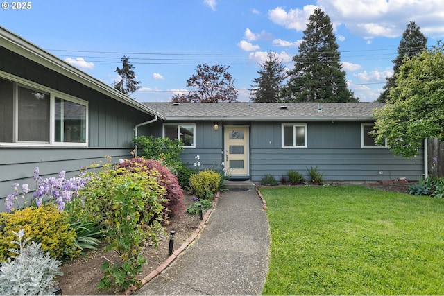 single story home featuring board and batten siding and a front yard