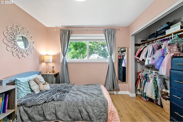 bedroom featuring baseboards and wood finished floors