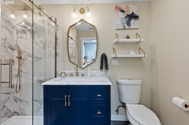 full bath with a marble finish shower, vanity, toilet, and visible vents