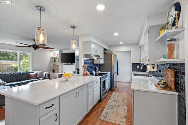 kitchen with open shelves, stainless steel range with electric stovetop, a peninsula, open floor plan, and a sink