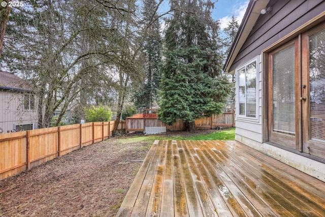 wooden terrace featuring a fenced backyard