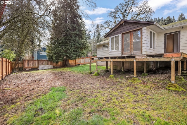 view of yard with a fenced backyard and a wooden deck